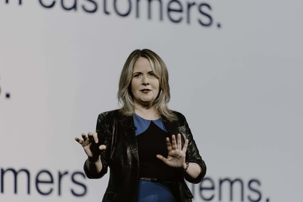 Professional speaker addressing audience on customer engagement at Glia tech event