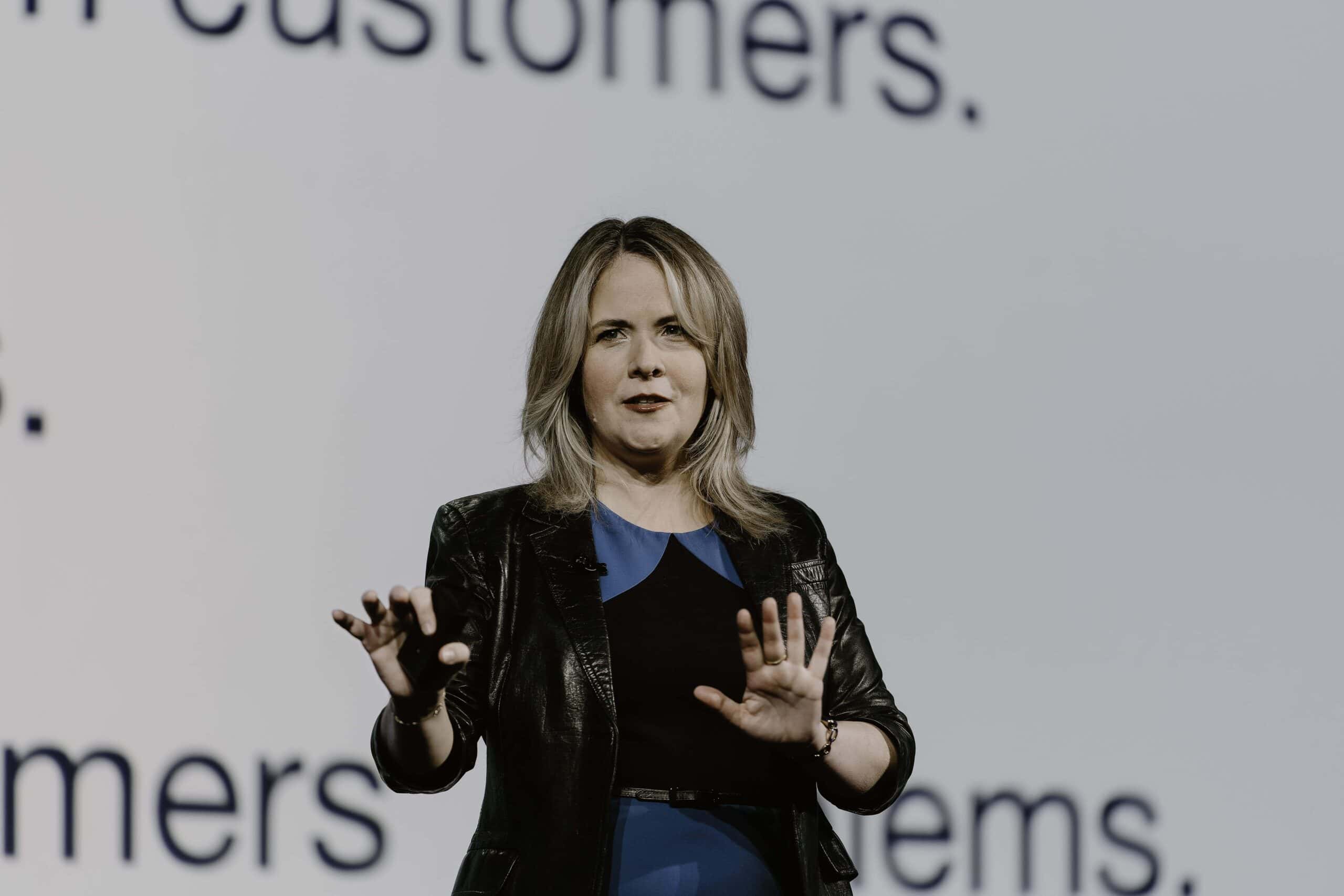 Professional speaker addressing audience on customer engagement at Glia tech event