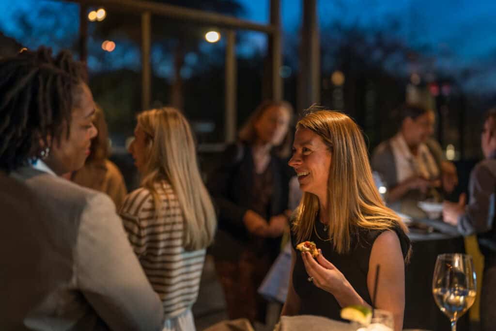 Woman enjoying hors d’oeuvres while networking at a Virginia Beach corporate event