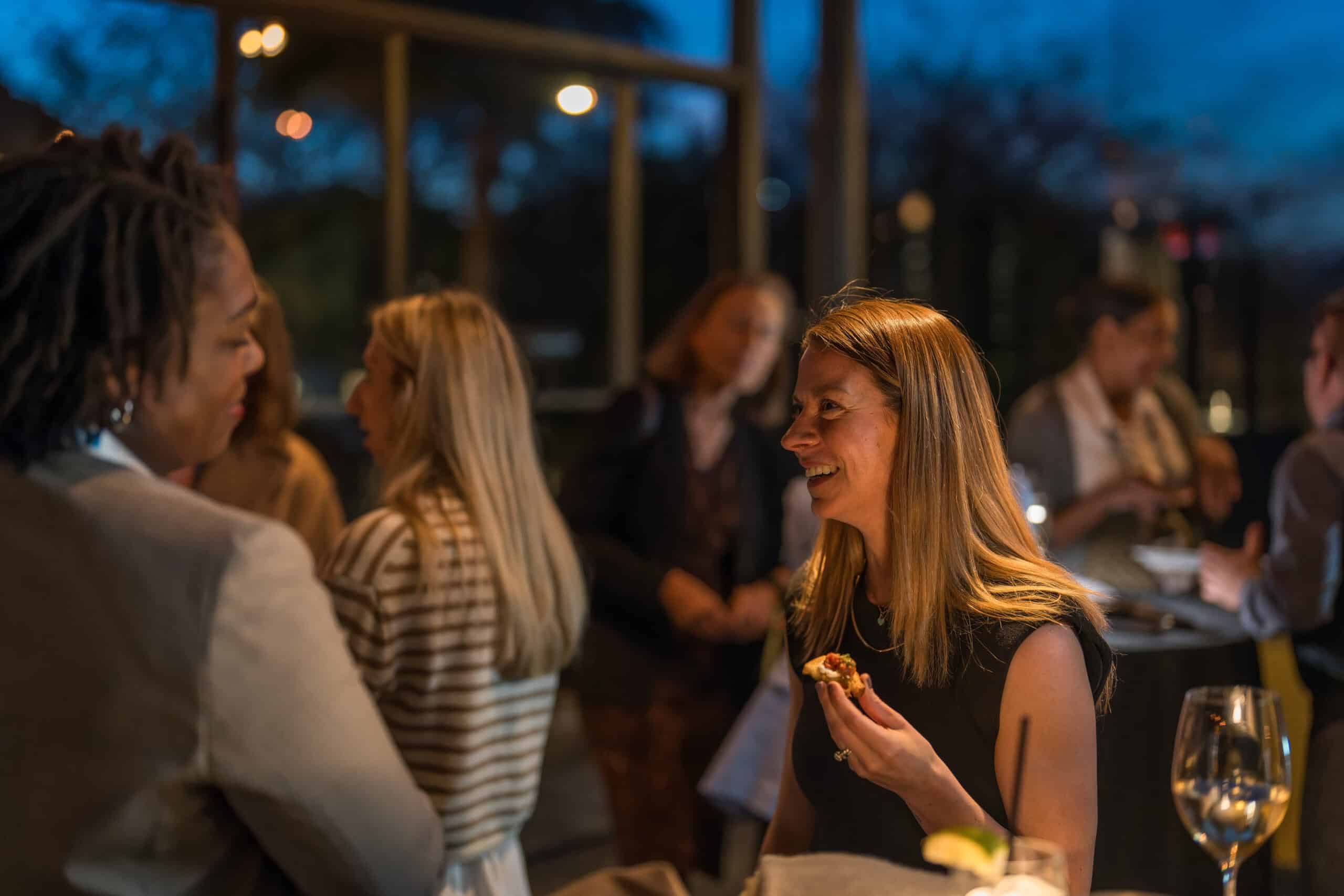 Woman enjoying hors d’oeuvres while networking at a Virginia Beach corporate event