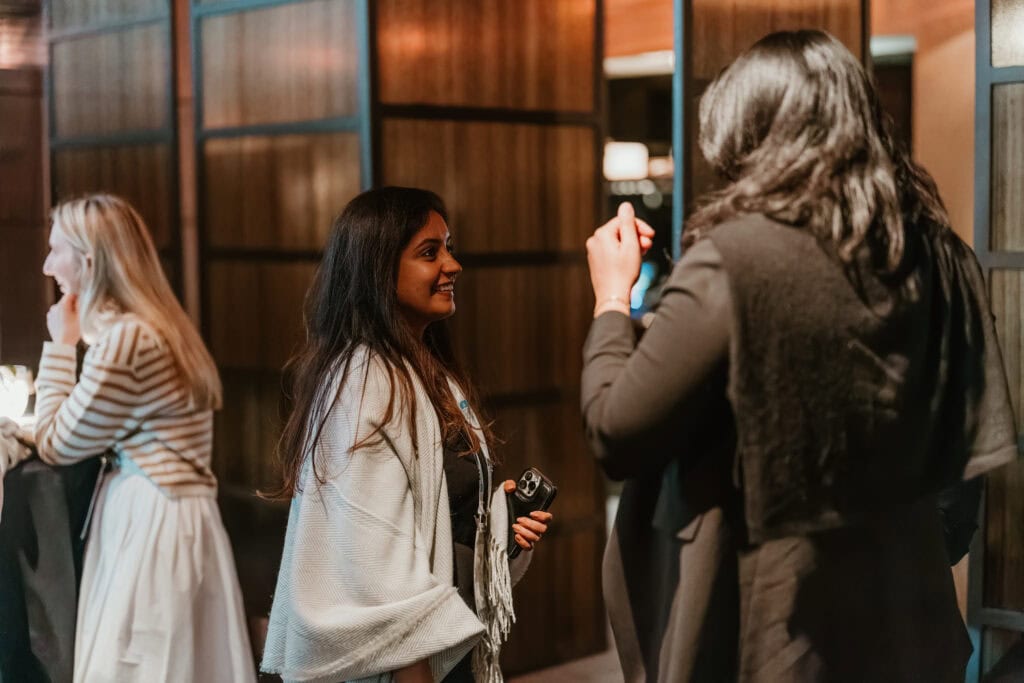 Two women networking during an evening business event in Virginia Beach