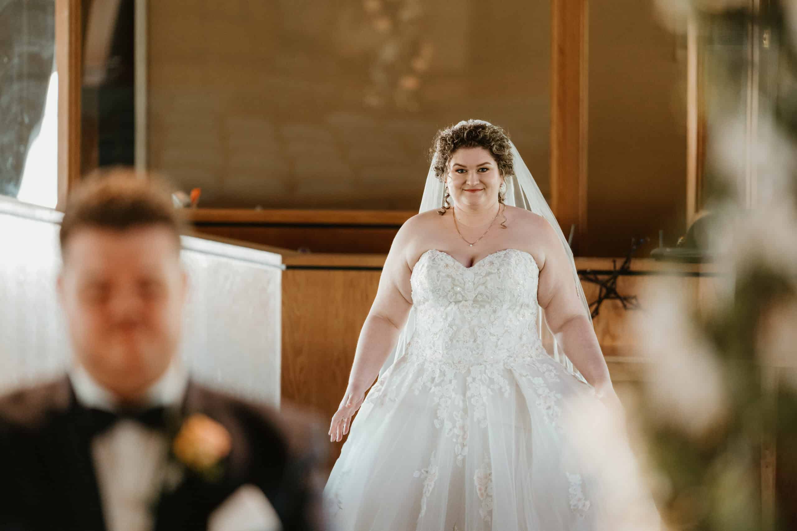 bride smiling and walking down aisle at Virginia Beach church wedding