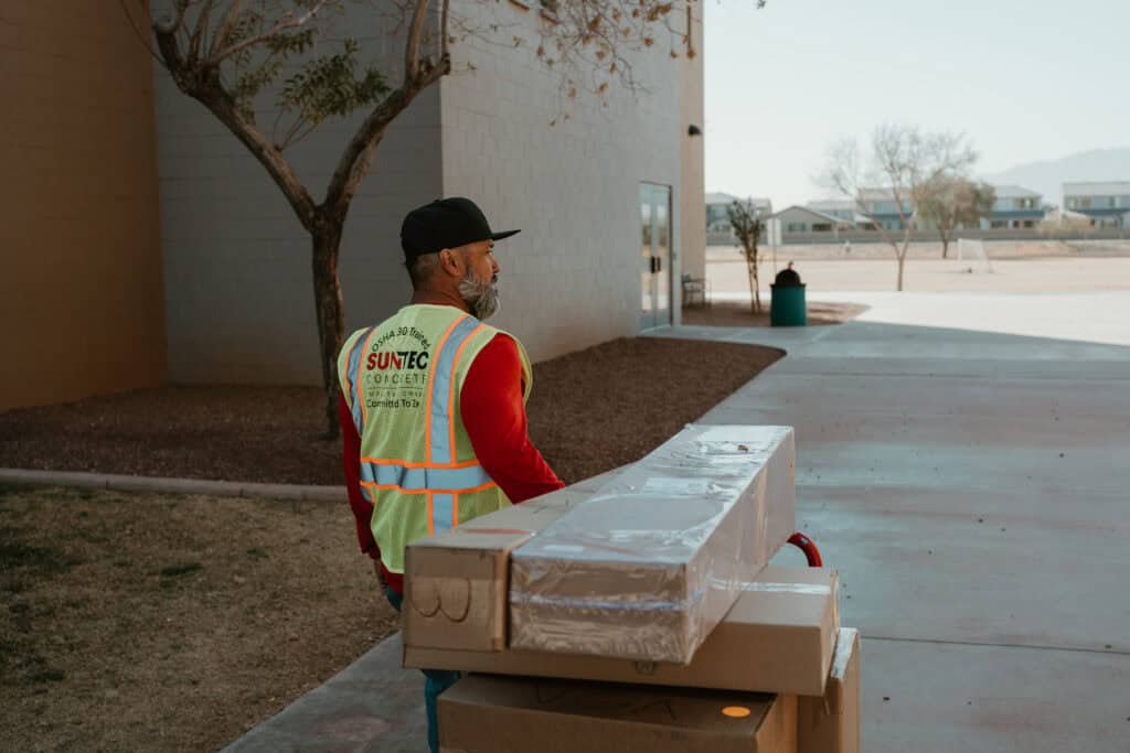 Construction worker delivering boxed supplies at a school campus in Virginia Beach