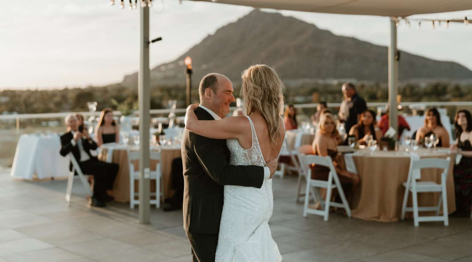 Bride and groom sharing first dance at elegant Virginia Beach rooftop wedding