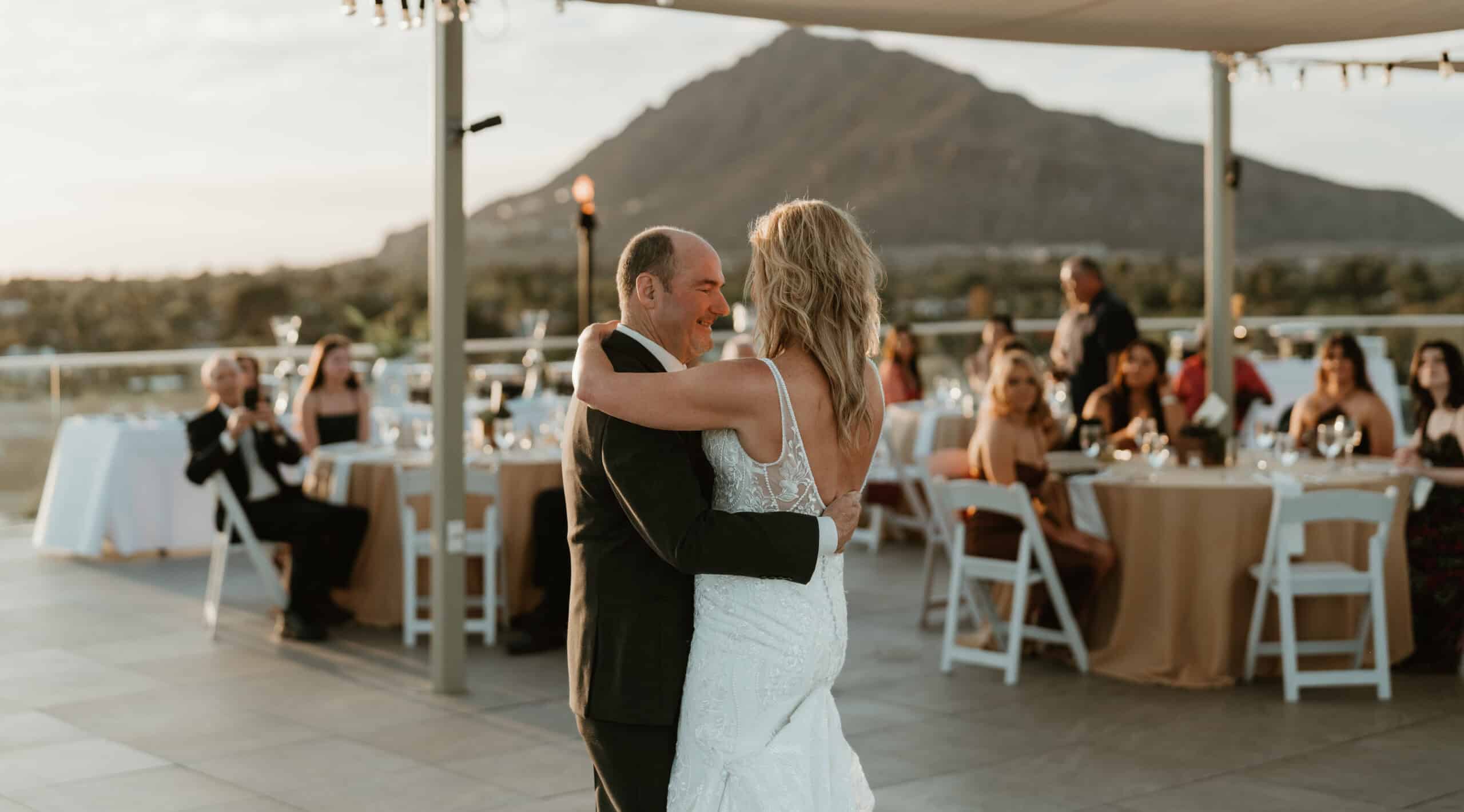 Bride and groom sharing first dance at elegant Virginia Beach rooftop wedding