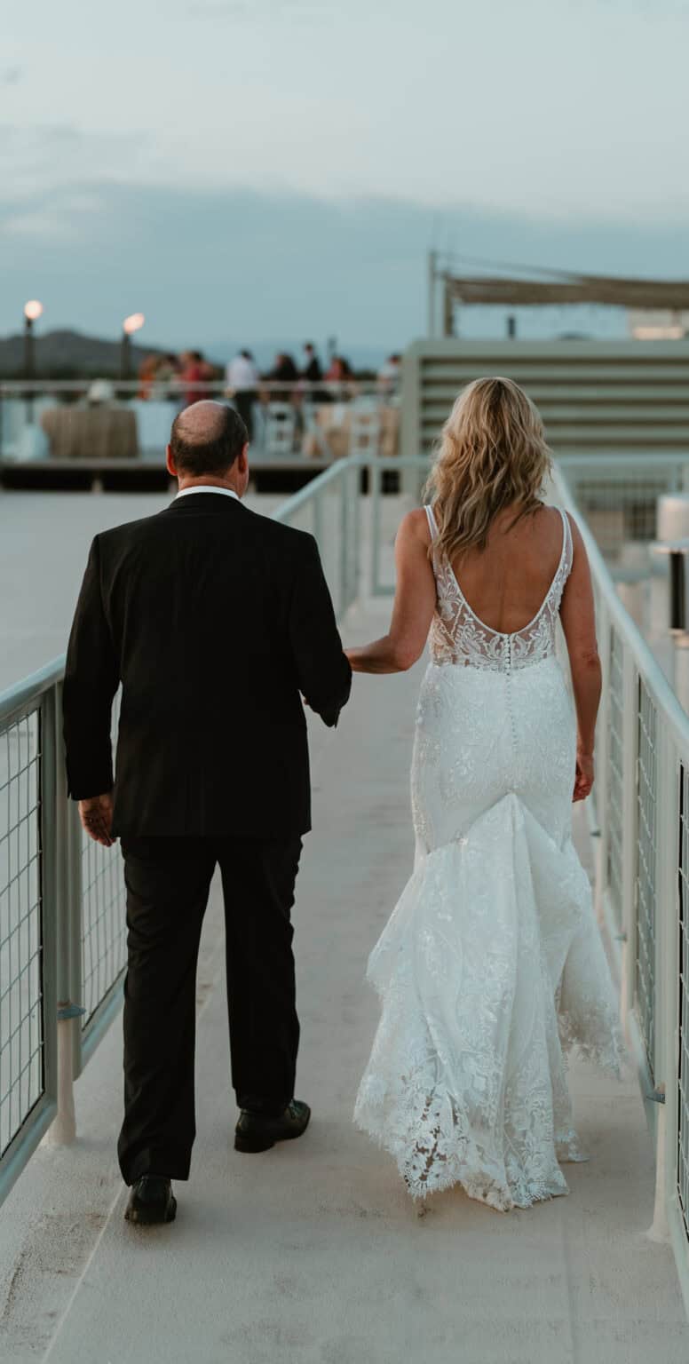 Bride and groom walking hand-in-hand after sunset at Virginia Beach wedding