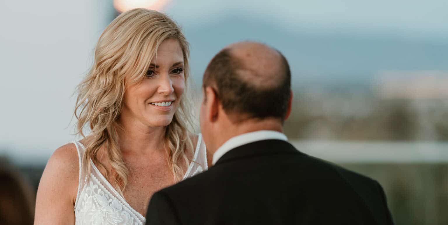 Bride smiling at groom during intimate wedding moment in Virginia Beach