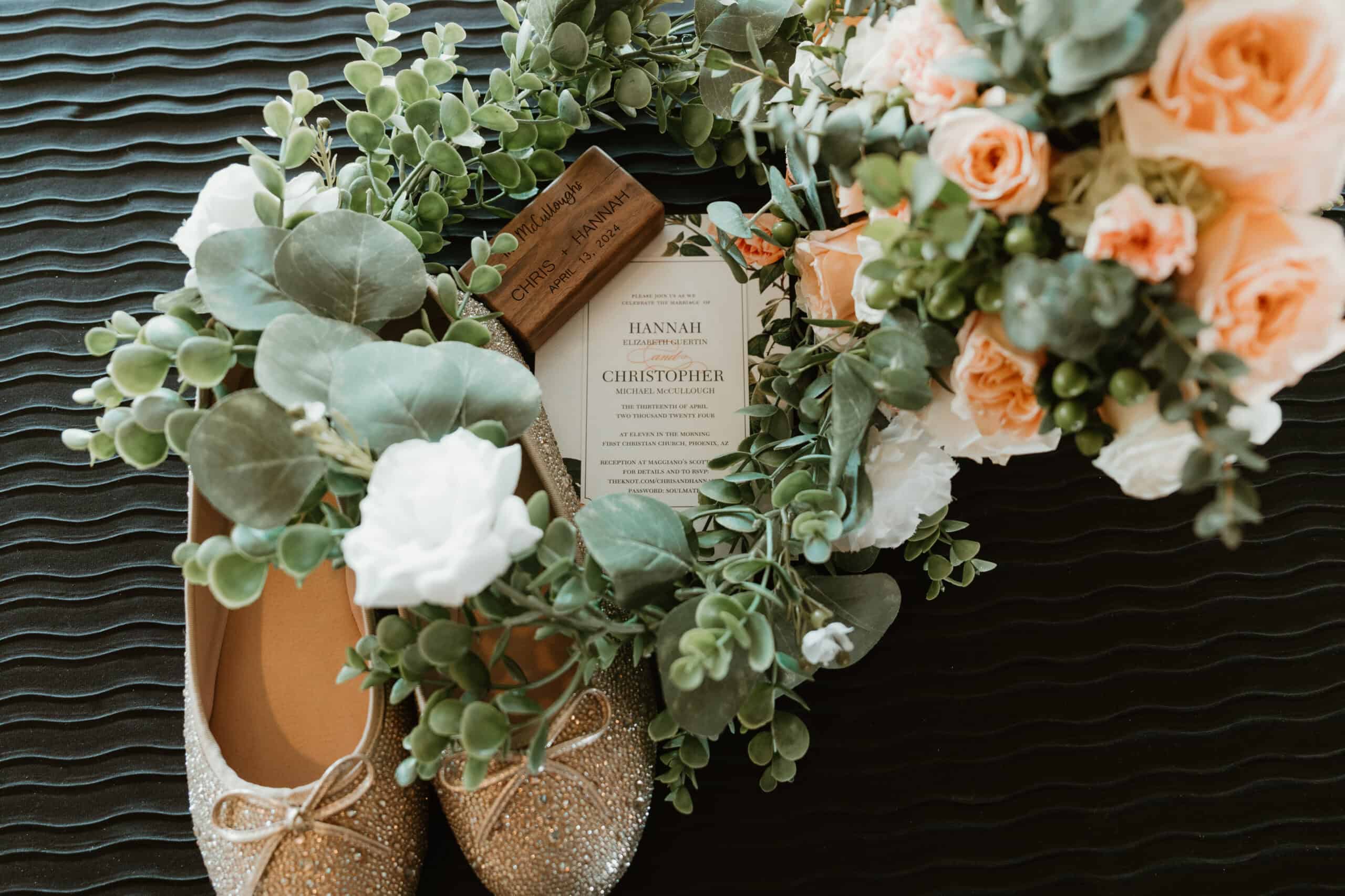 Flat lay of wedding details with golden shoes, greenery, and invitation for Virginia Beach wedding