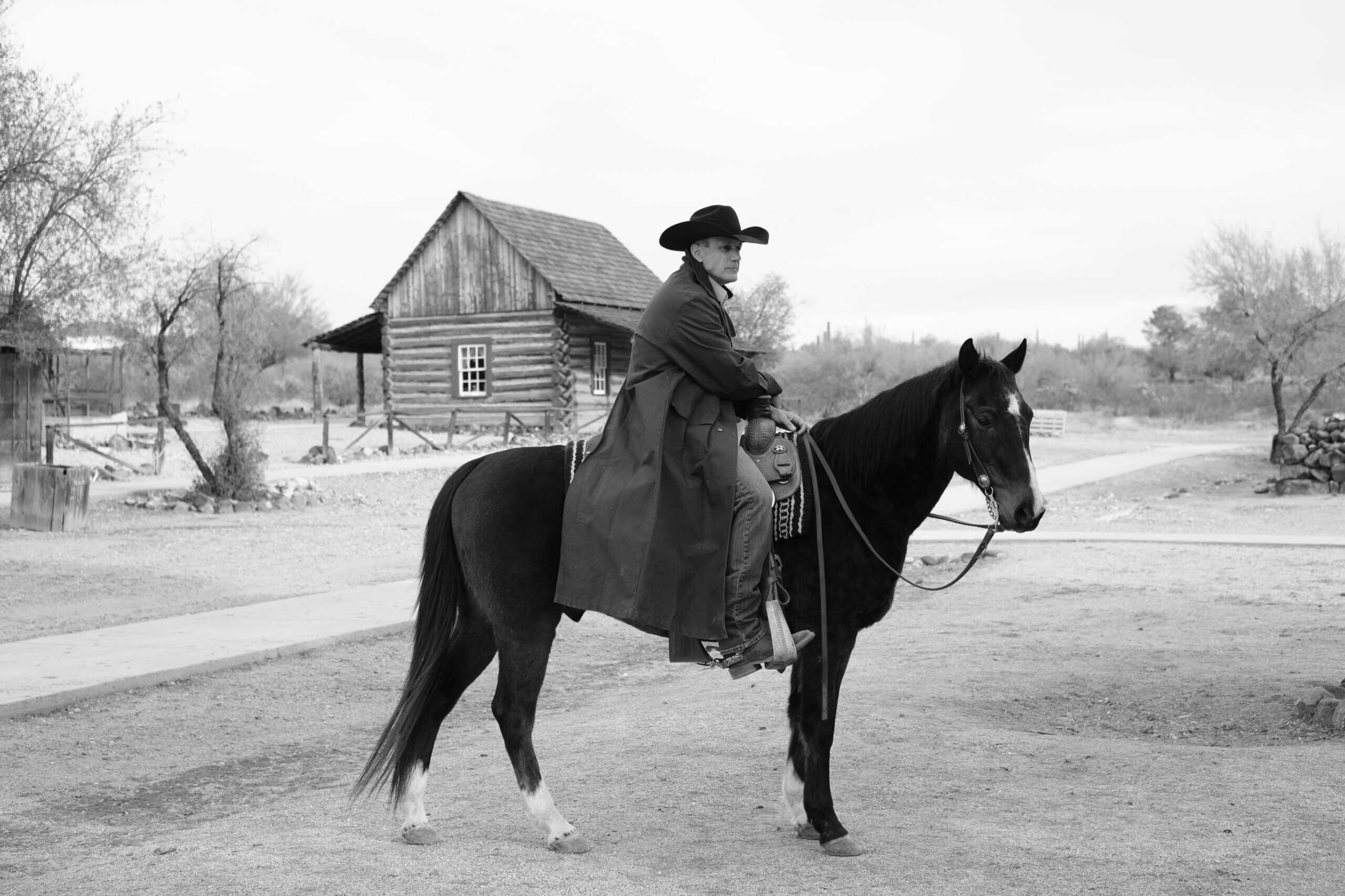 Cowboy on horseback at a rustic outdoor venue during a themed corporate event