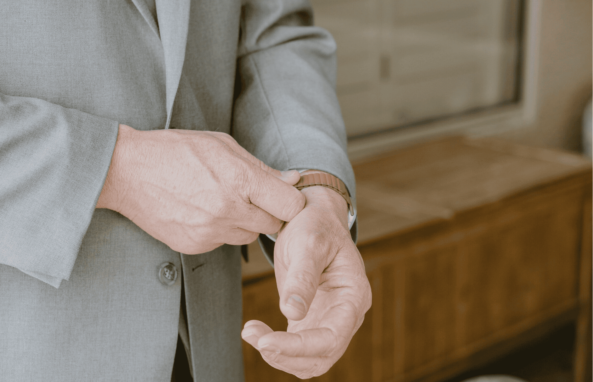 Close-up of groom adjusting his watch during wedding prep, photographed by a Virginia Beach wedding photographer