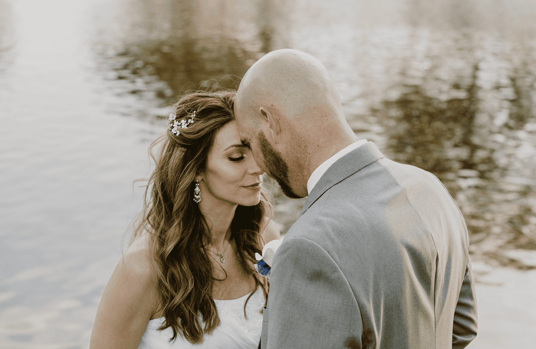 Bride and groom sharing a quiet moment by the lake during their wedding in Hampton Roads, captured by Captured in VA photography