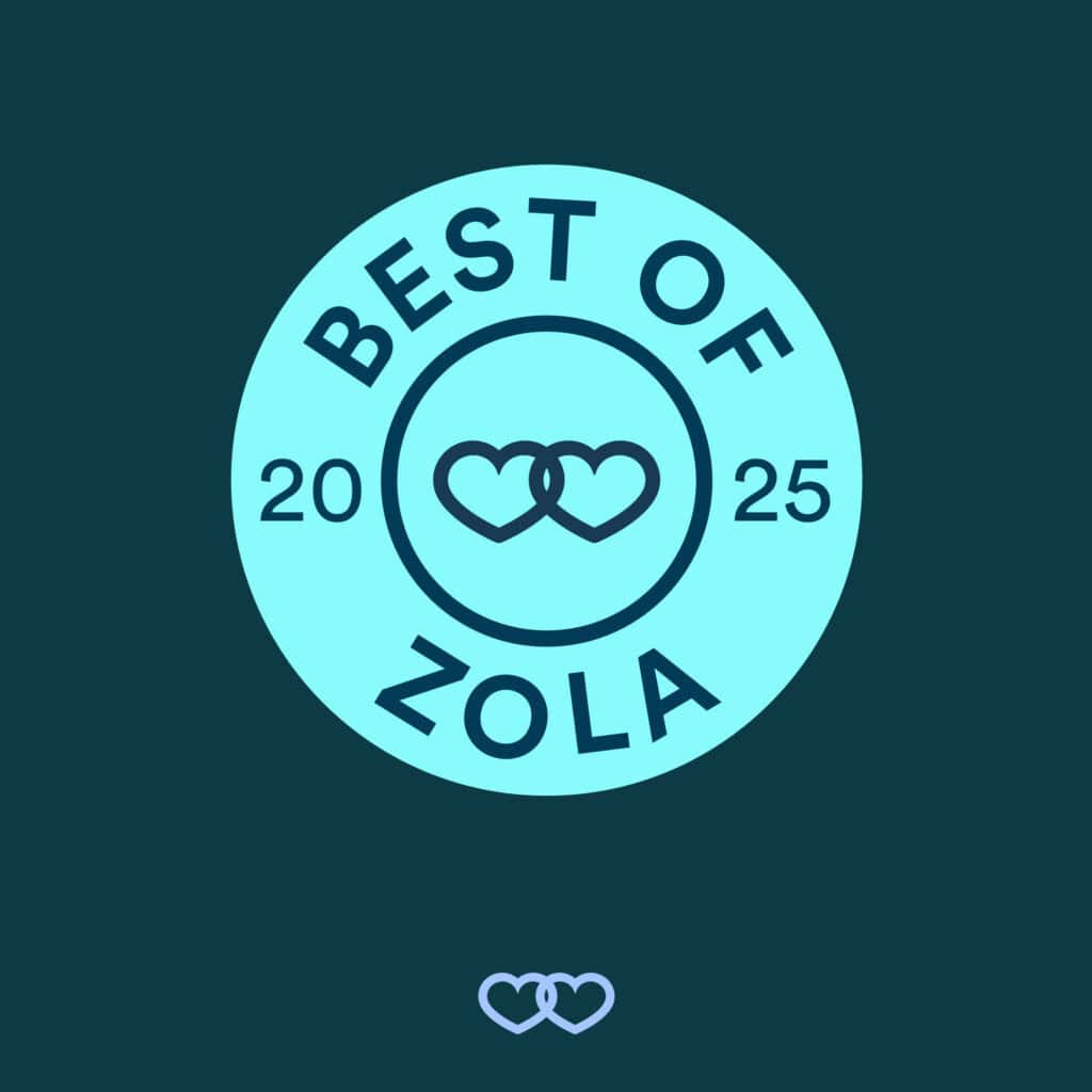 Official "Best of Zola 2025" award badge. The light blue circular seal features the text "BEST OF ZOLA 2025" and a central icon of two interconnected hearts, recognizing a top-rated wedding vendor.