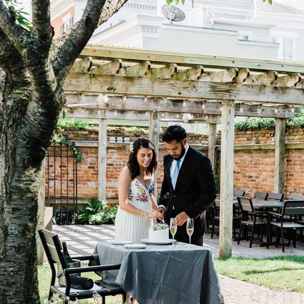  Envision idyllic wedding photos at The Inn at Four Eleven’s stone bridge. Norfolk Wedding Photographer delivers timeless imagery with charming architecture, serene water reflections, and lush greenery.