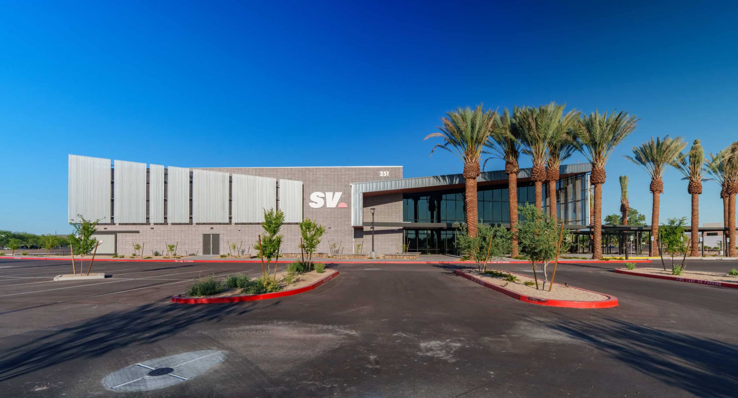 Wide exterior view of the Sun Valley Community Church building and palm-lined parking lot, architectural photography by Captured in VA.